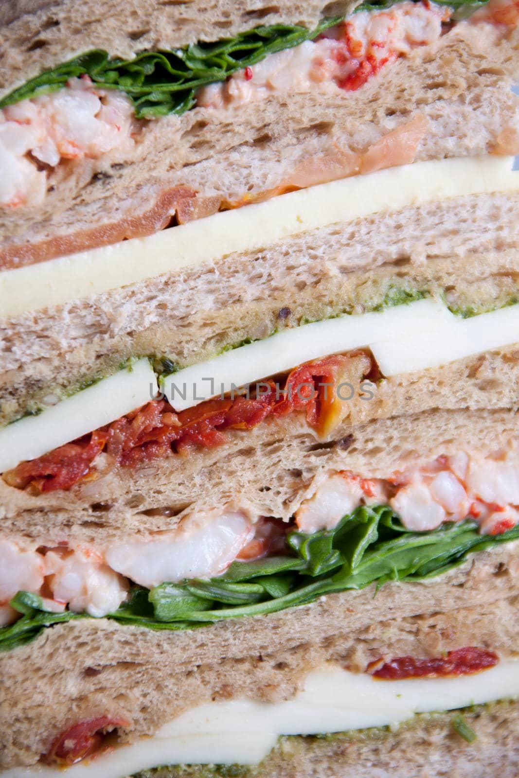 A pile of sandwiches close up showing fillings