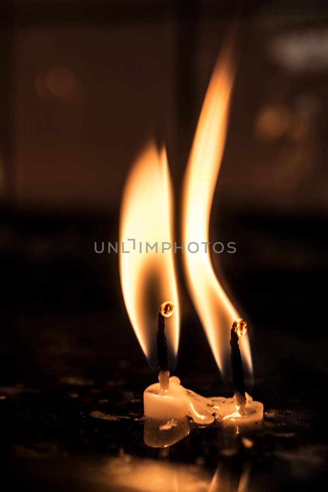  burning candle making light in view as a background by berkay