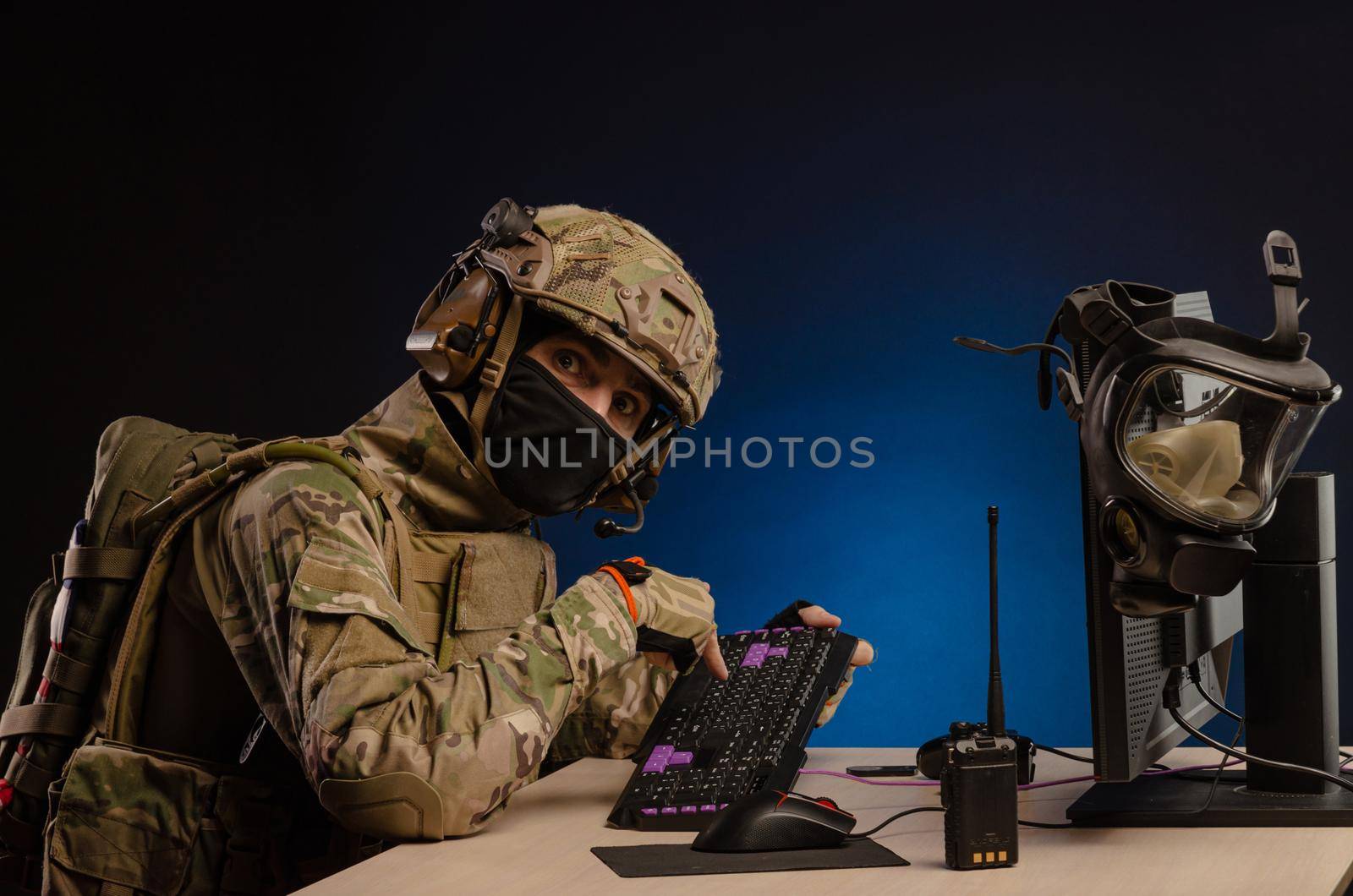 soldier sitting at a computer is conducting a cyber war