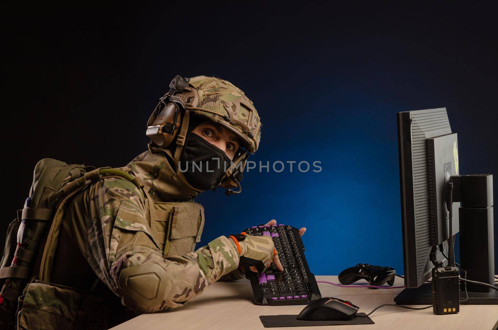 soldier sitting at a computer is conducting a cyber war