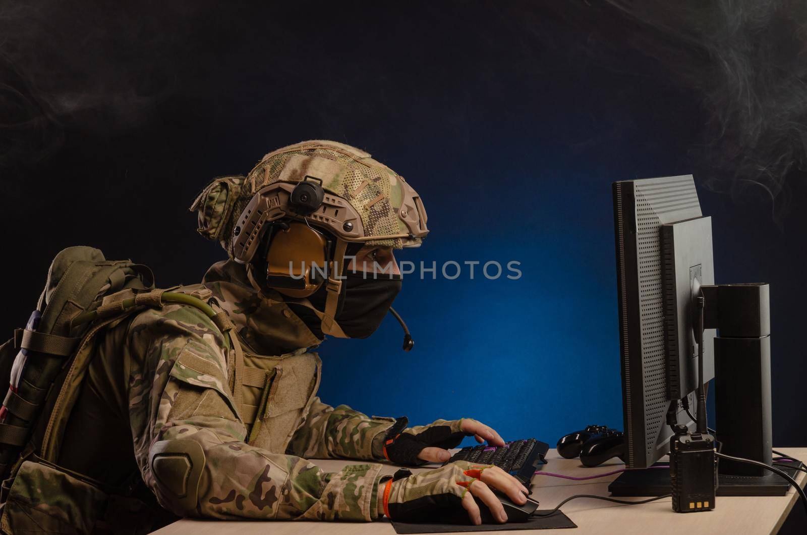 soldier sitting at a computer is conducting a cyber war