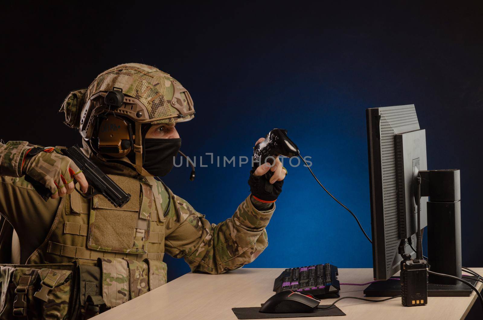 soldier sitting at a computer is conducting a cyber war by Rotozey