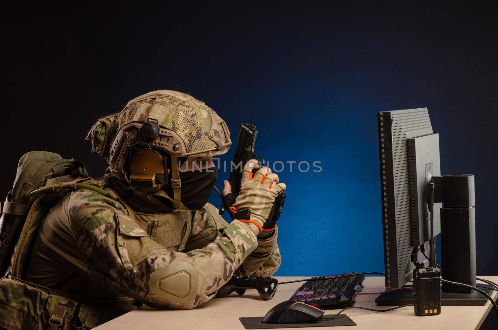 soldier sitting at a computer is conducting a cyber war