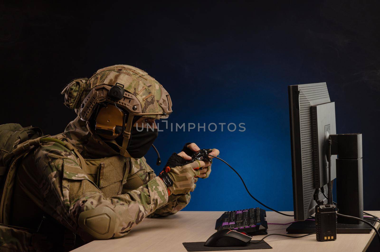 soldier sitting at a computer is conducting a cyber war