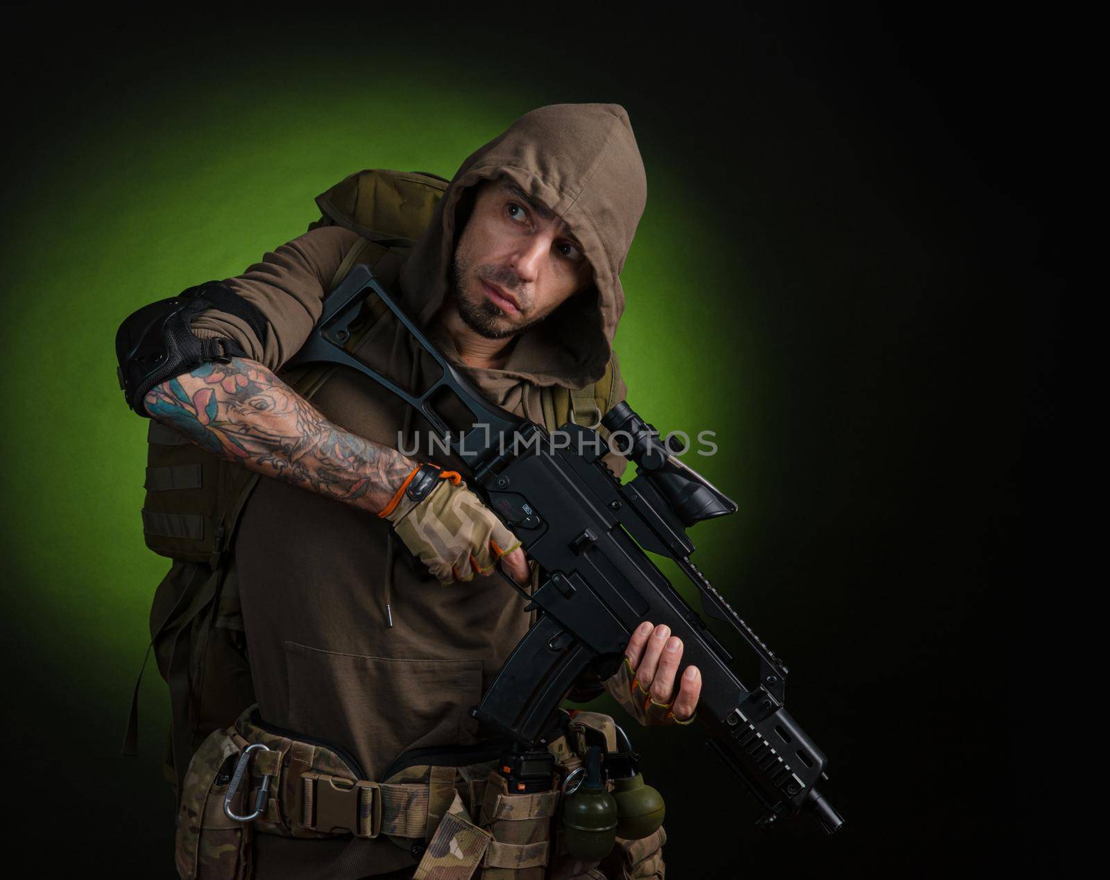 man Stalker with a gun with an optical sight and a backpack on a dark background by Rotozey