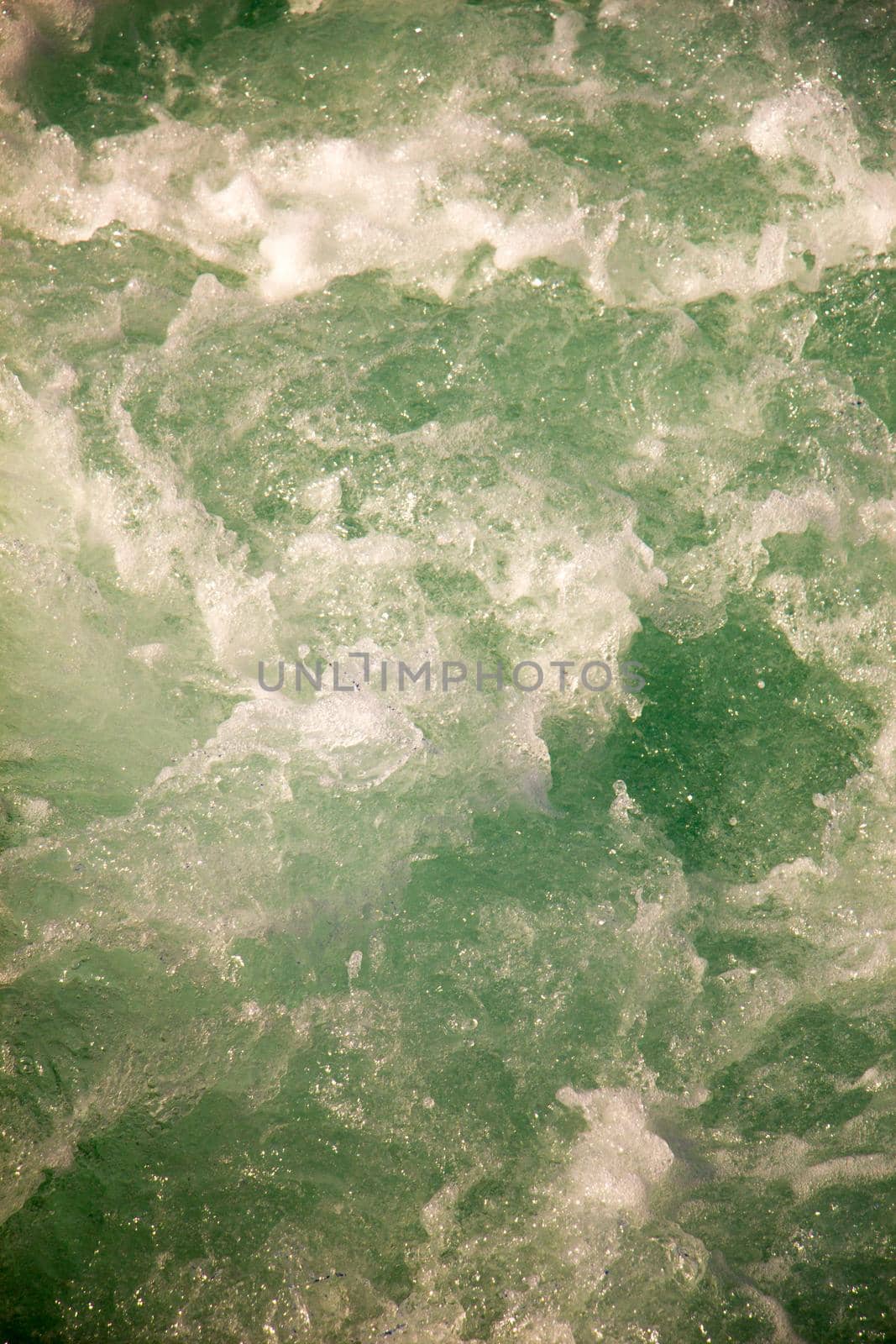 Water surface as a background with foam and bubbles