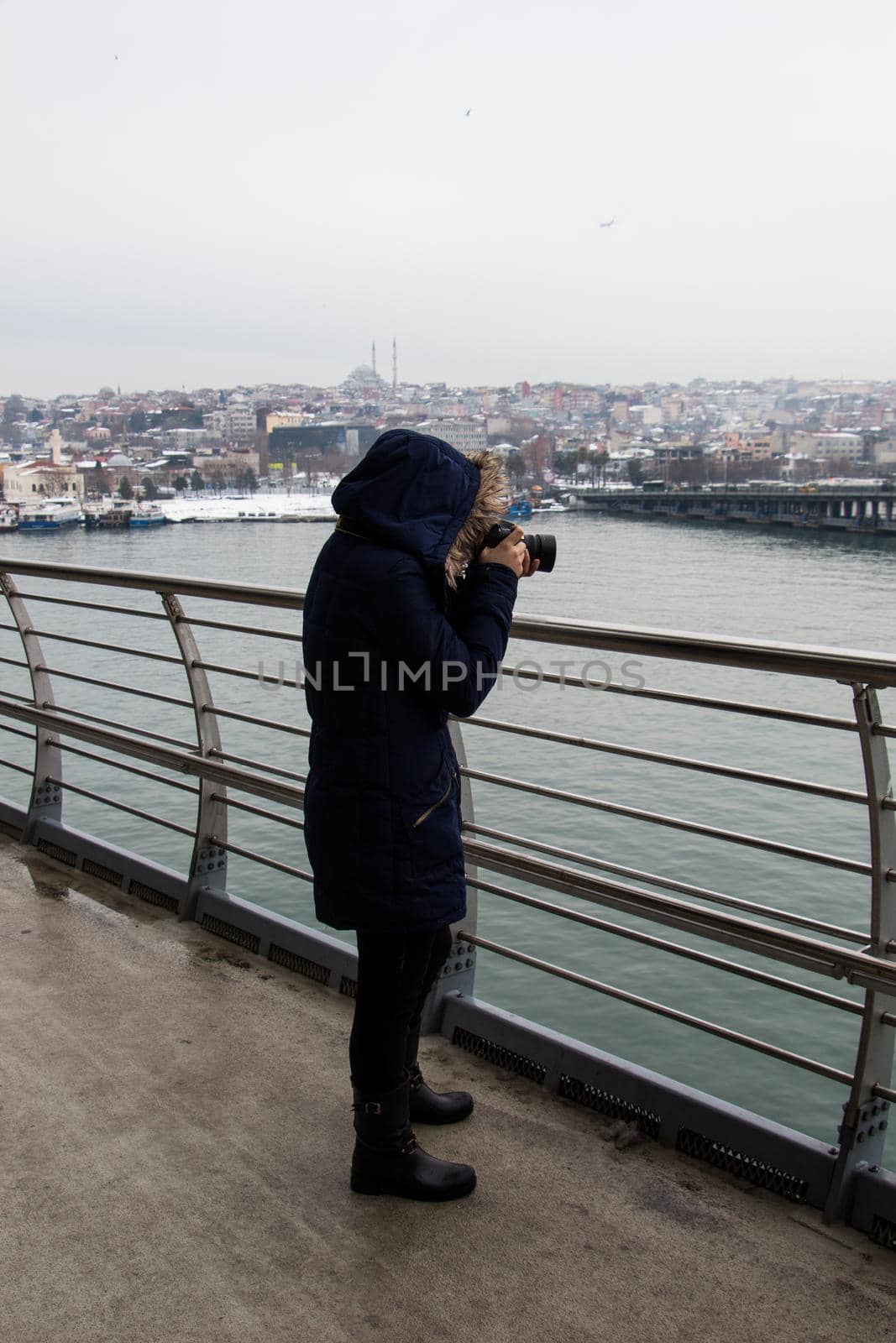 tourist girl photographer with dslr camera outdoor on the bridge by berkay
