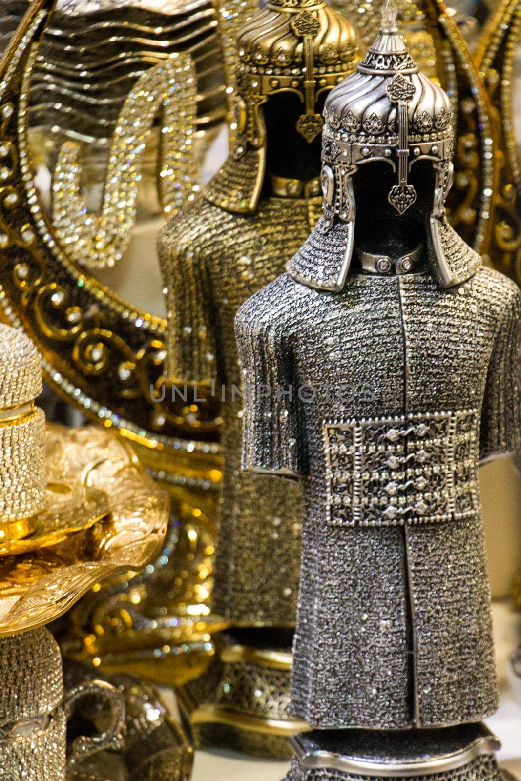 Medieval steel and gold colored armours on display by berkay