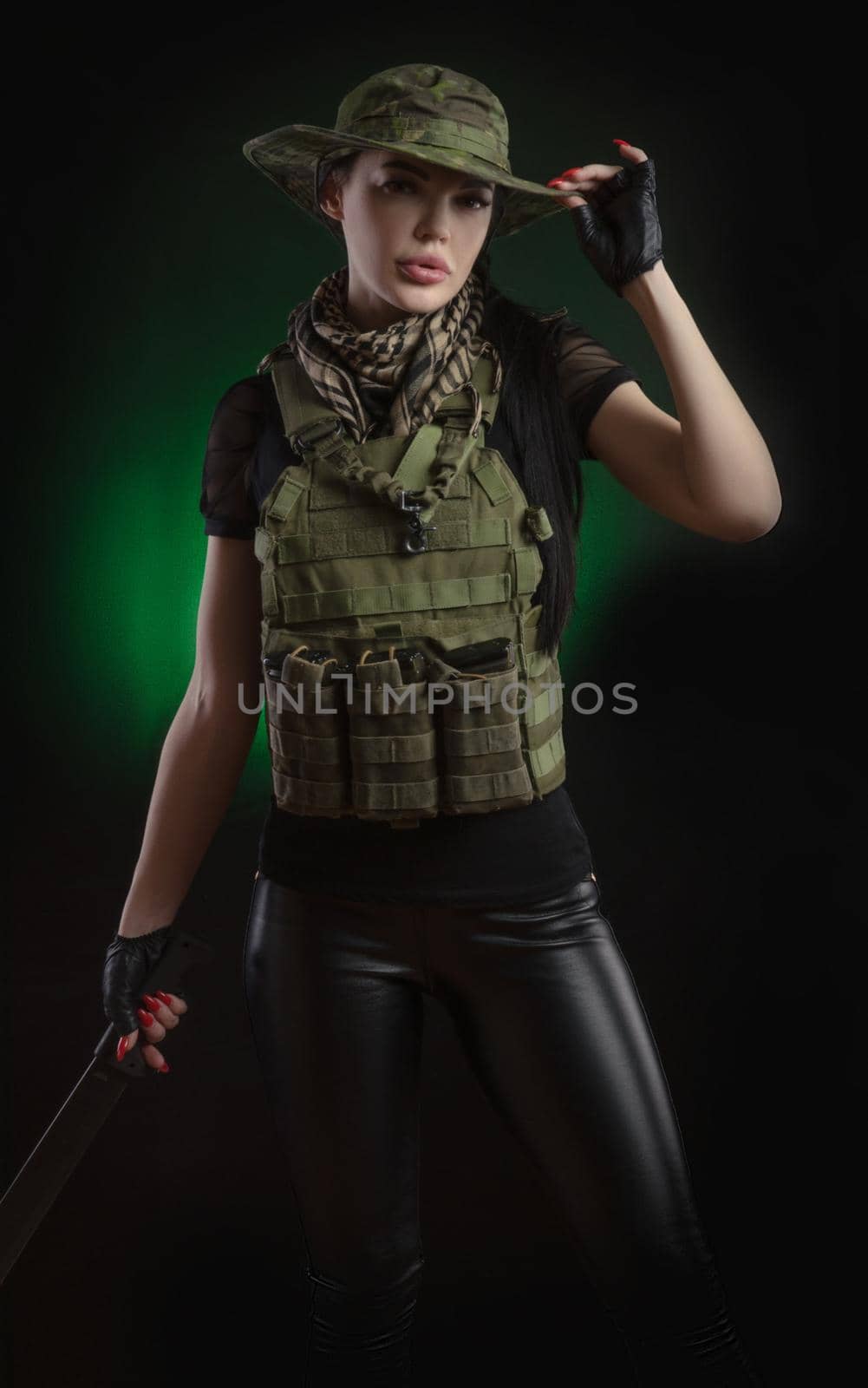 the girl in military special clothes posing with a gun in his hands on a dark background in the haze by Rotozey