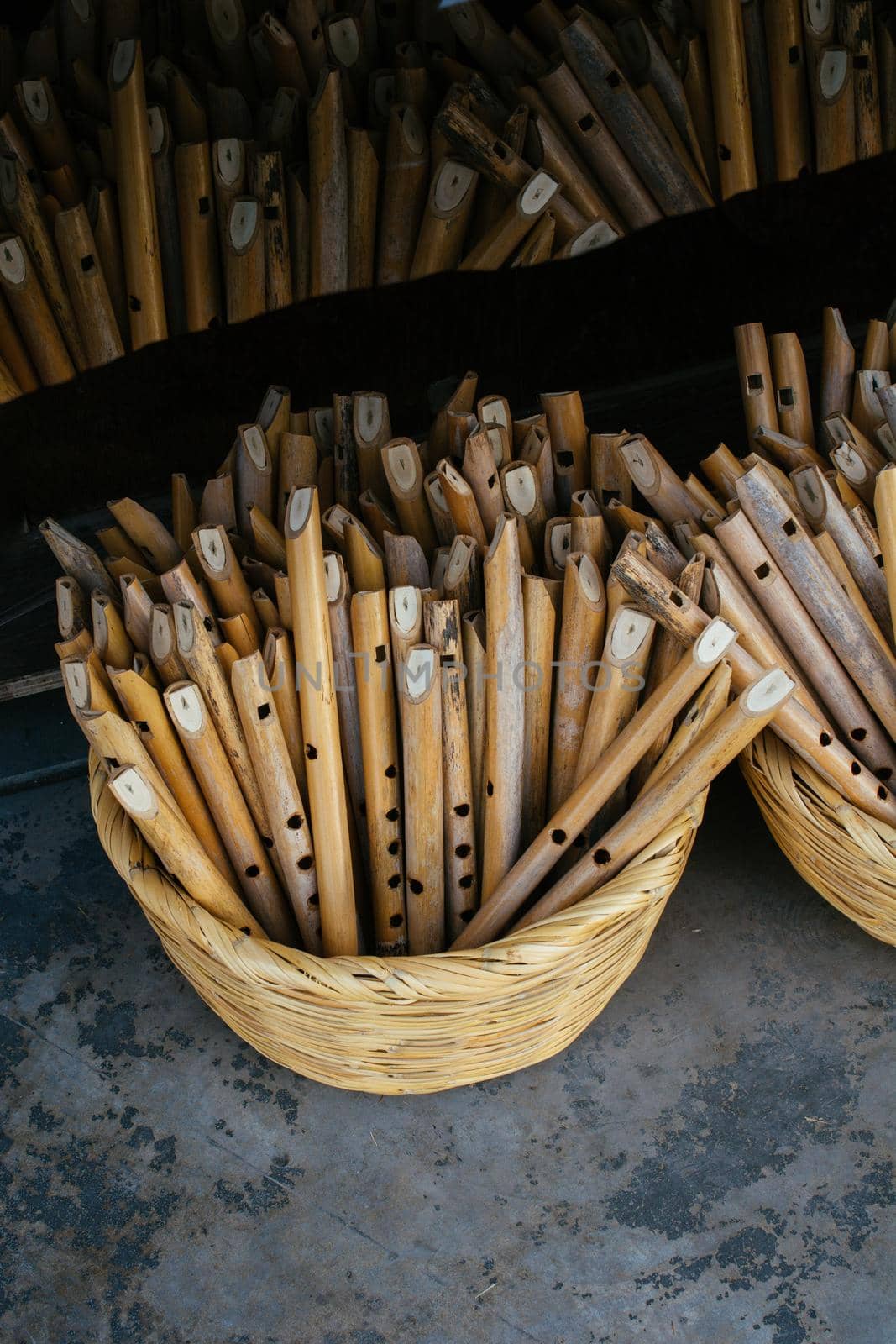 Dozens of handmade wooden flutes in display by berkay