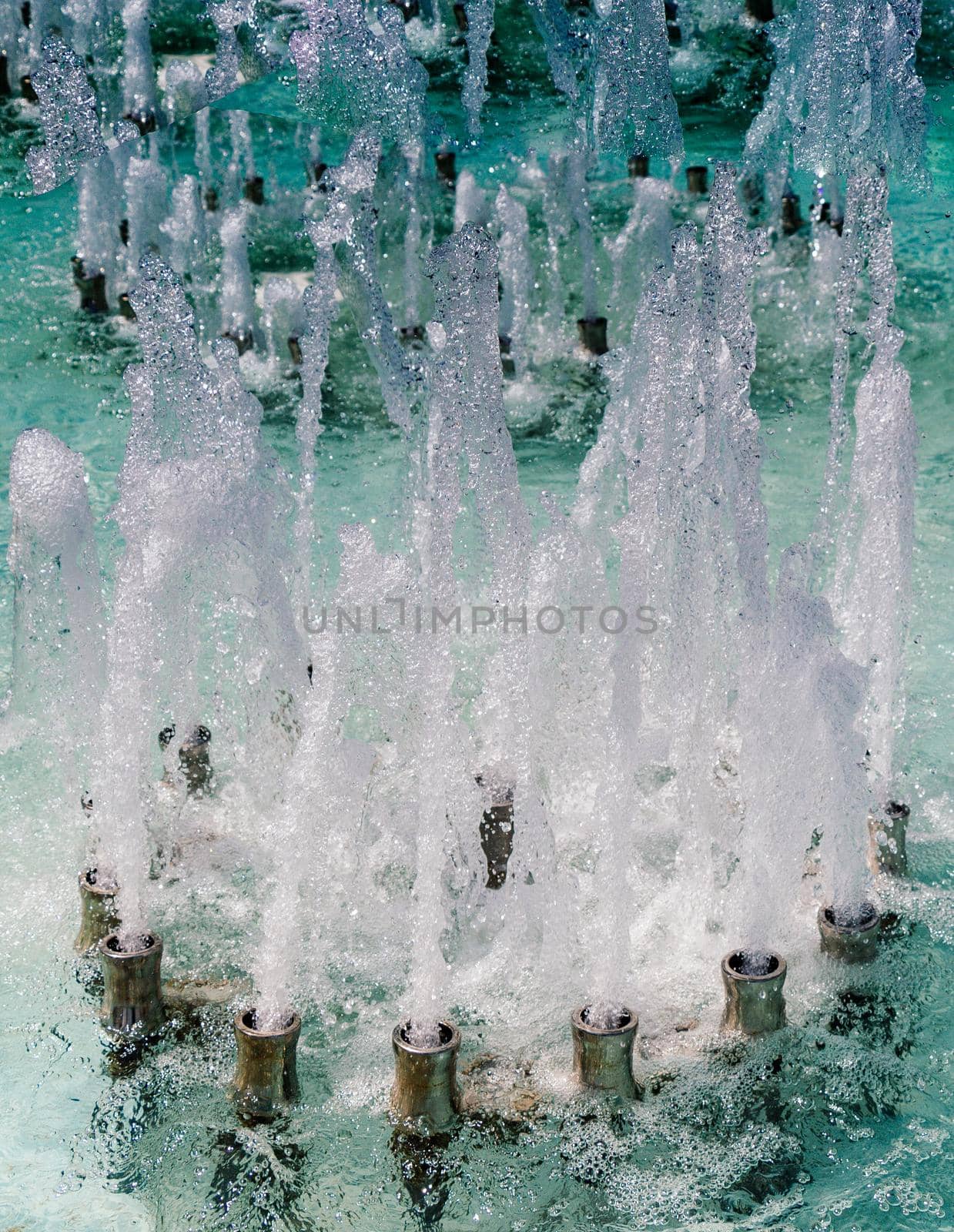 The fountains gushing sparkling water in a pool by berkay