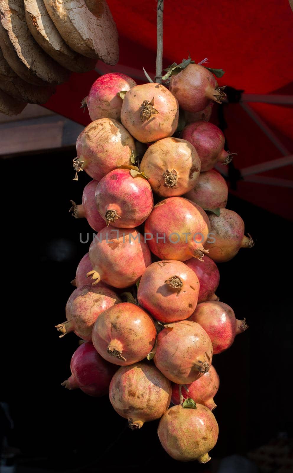 Ripe pomegranate fruit at a market place  by berkay