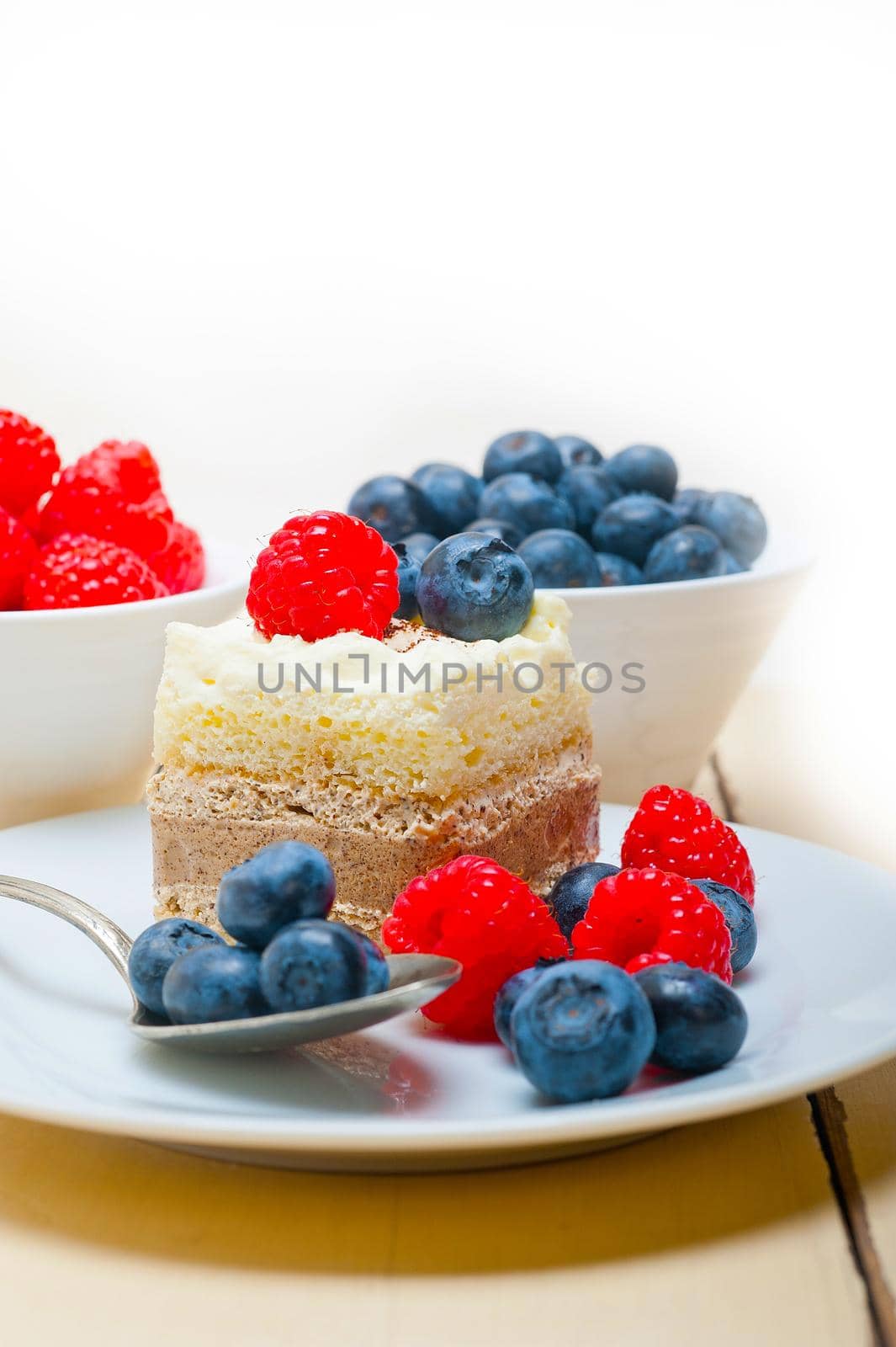 fresh homemade raspberry and blueberry cream cake 