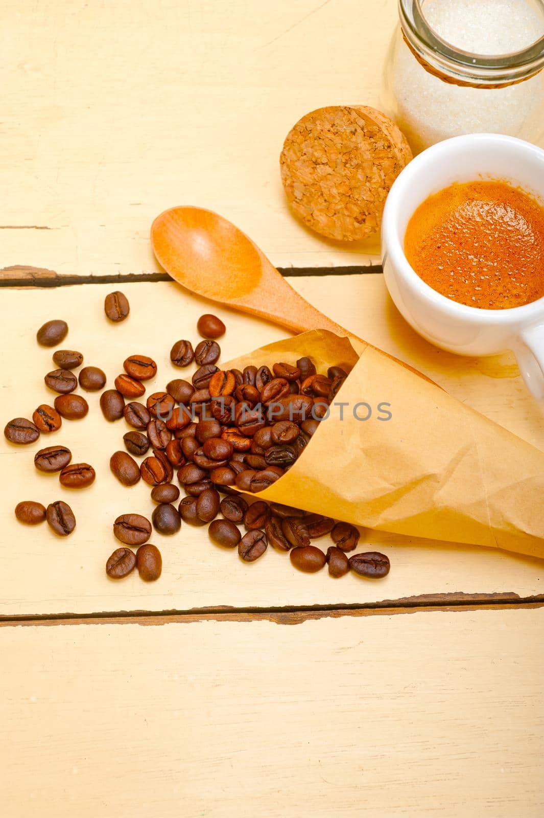 espresso coffee and beans on a paper cone cornucopia over white background