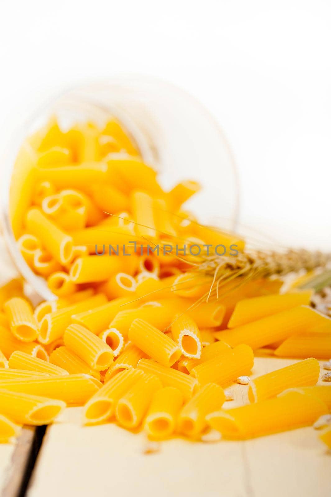 short Italian pasta penne with durum wheat grains