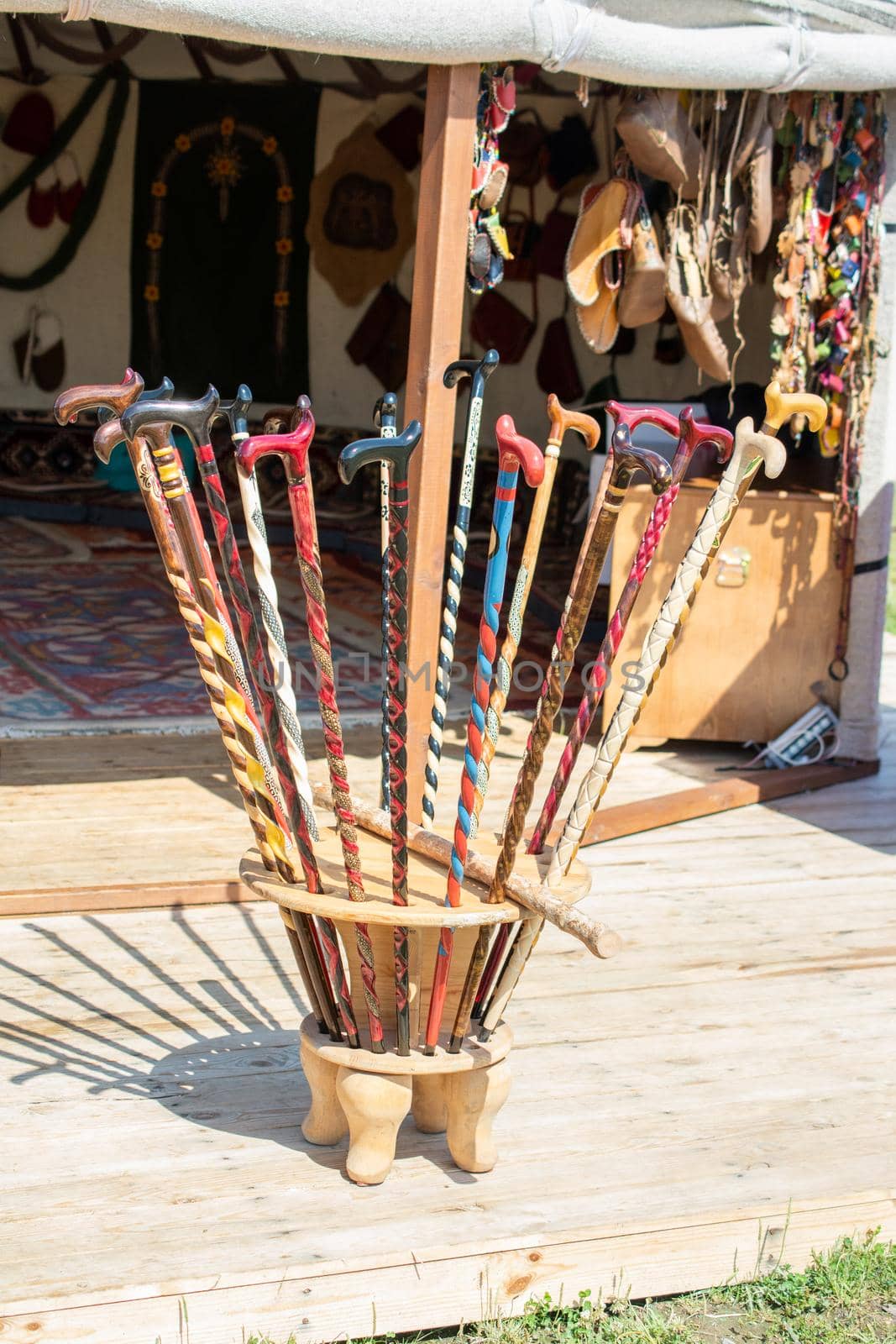 Colorful decorative wooden walking sticks on display by berkay