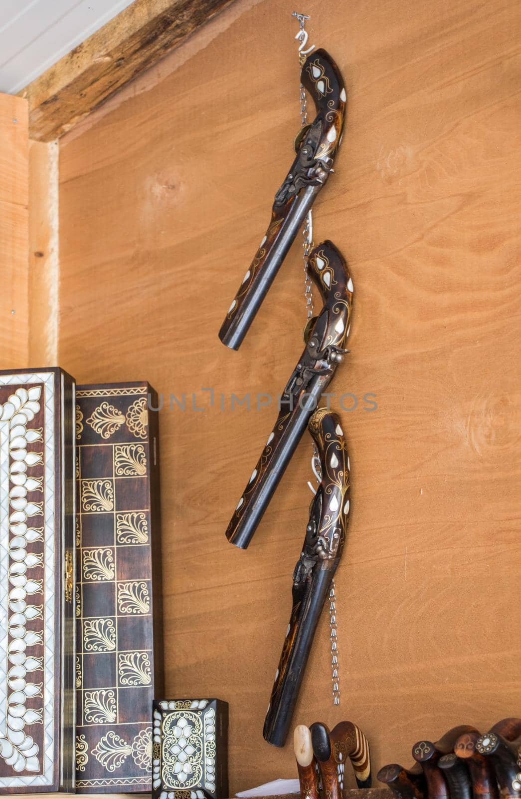 Antique stylistic revolve-like gun on a wooden background