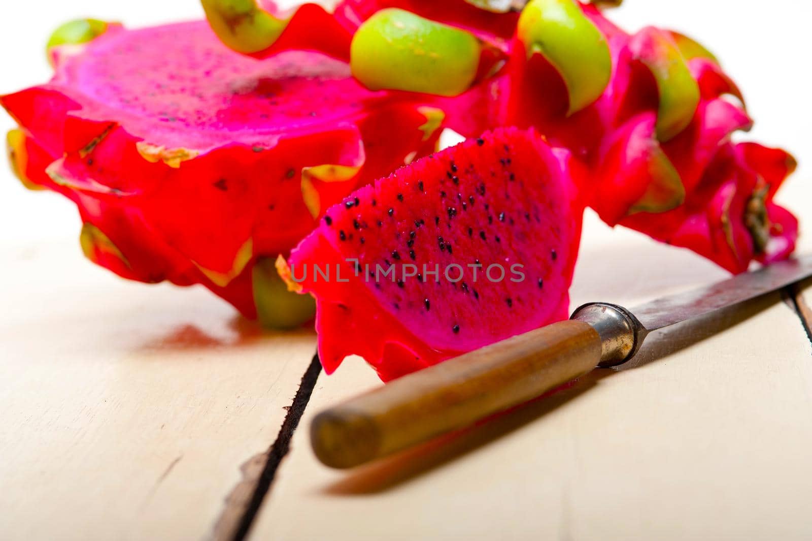 fresh thai purple dragon fruit over white rustic table