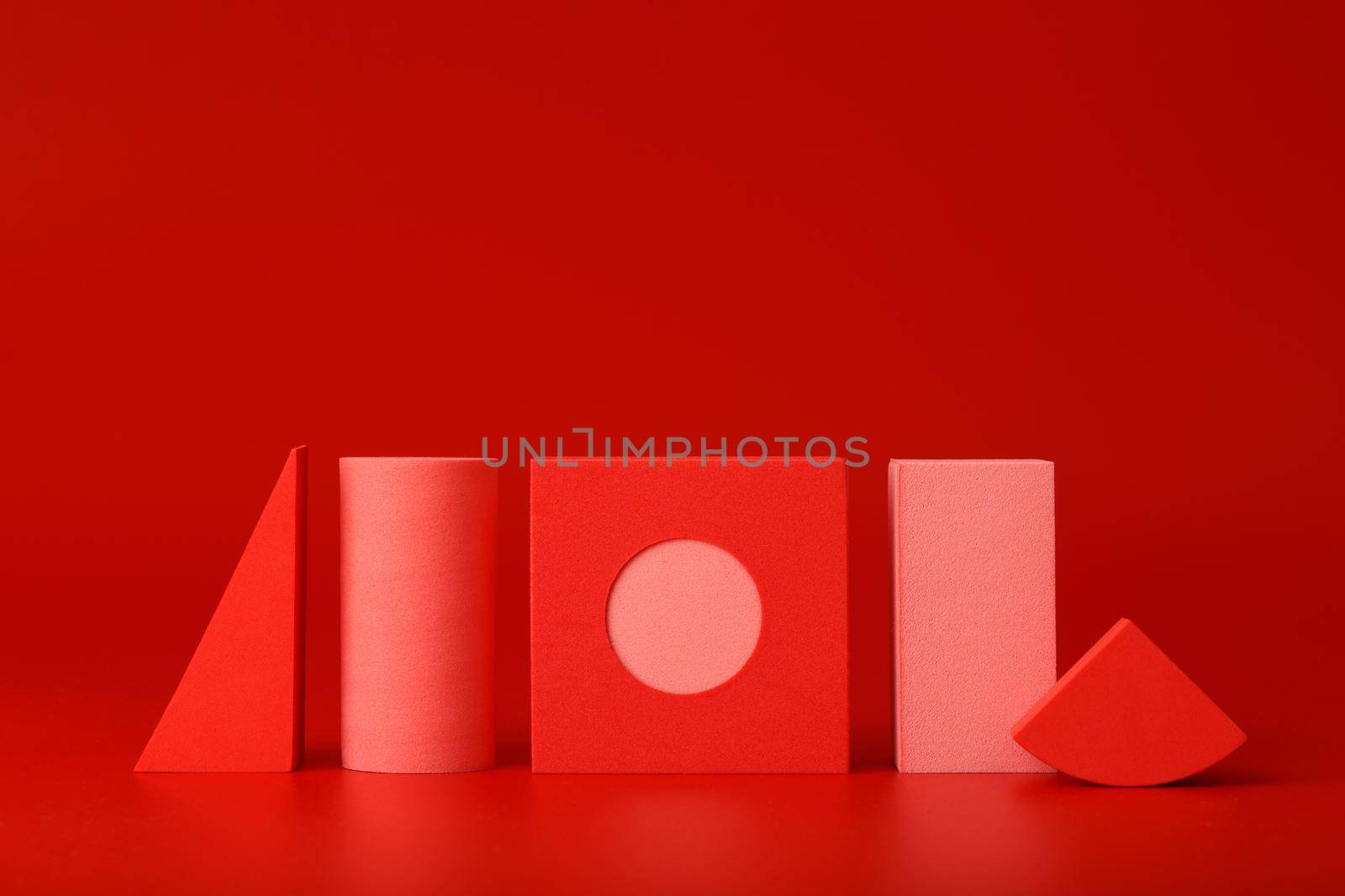 Artsy red abstract background with red and pink geometric figures against red background with copy space. Concept of minimal futuristic template for design or banner