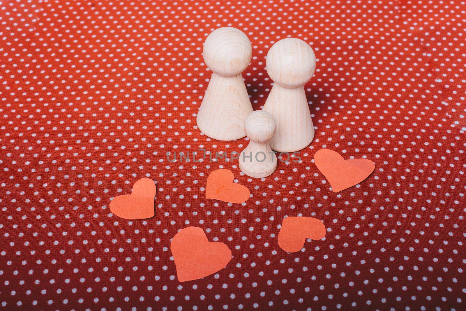 Wooden figurines of  family as concept of caring for children