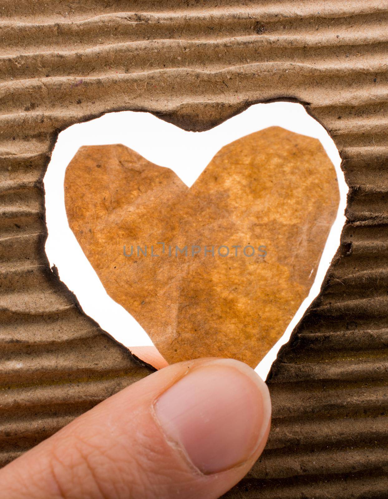 Heart shaped cut out of a brown cardboard