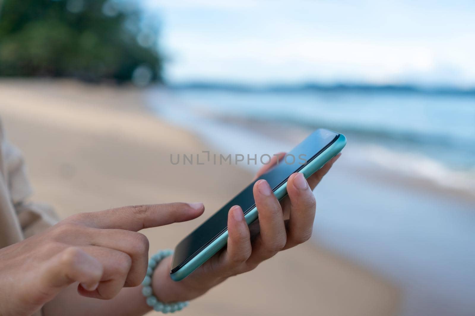 Woman hand using smartphone to do work business, social network, communication. by Suwant