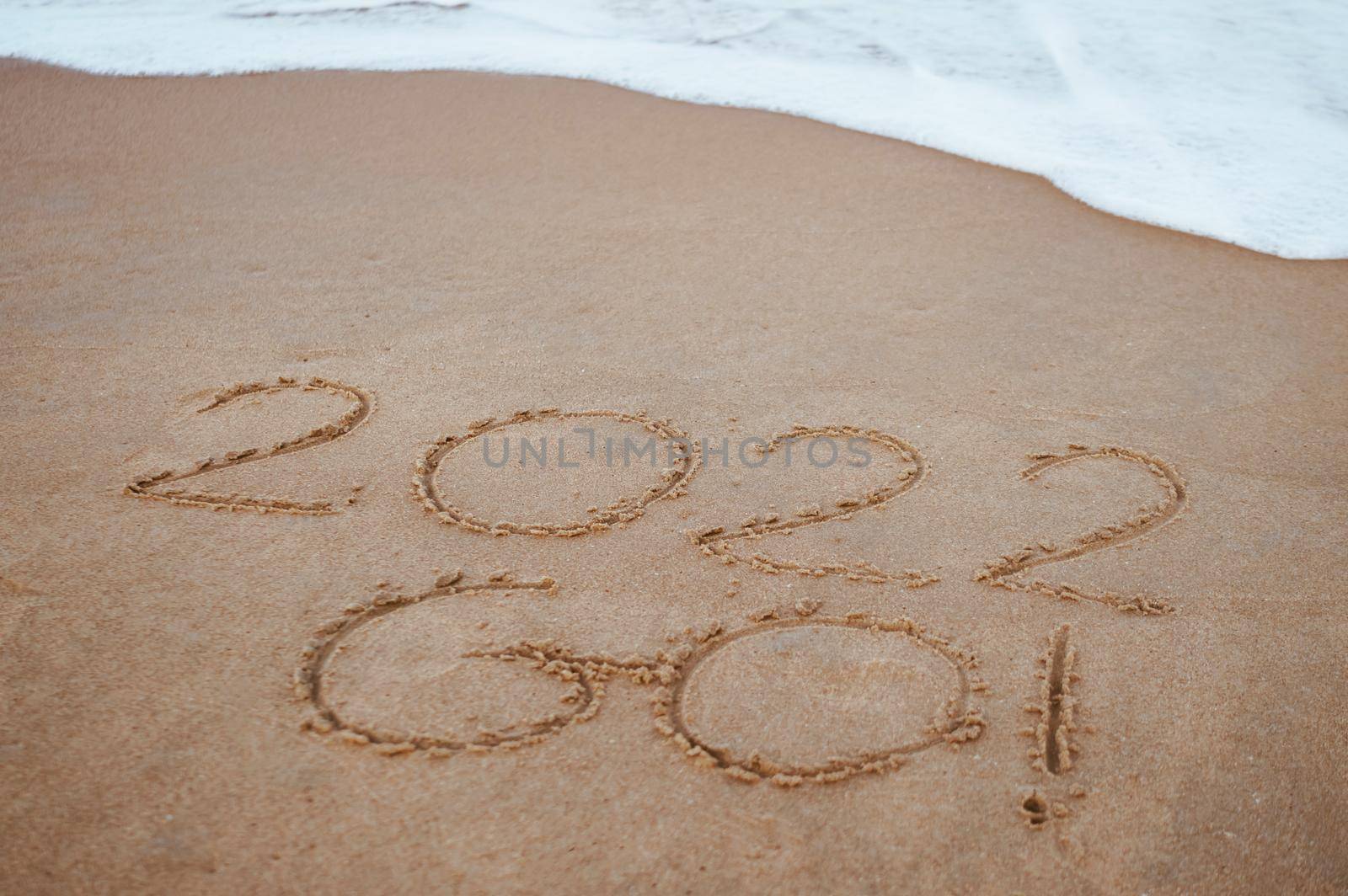 Start and go 2022 on the sand at the beach to show life ahead next year. background by Suwant