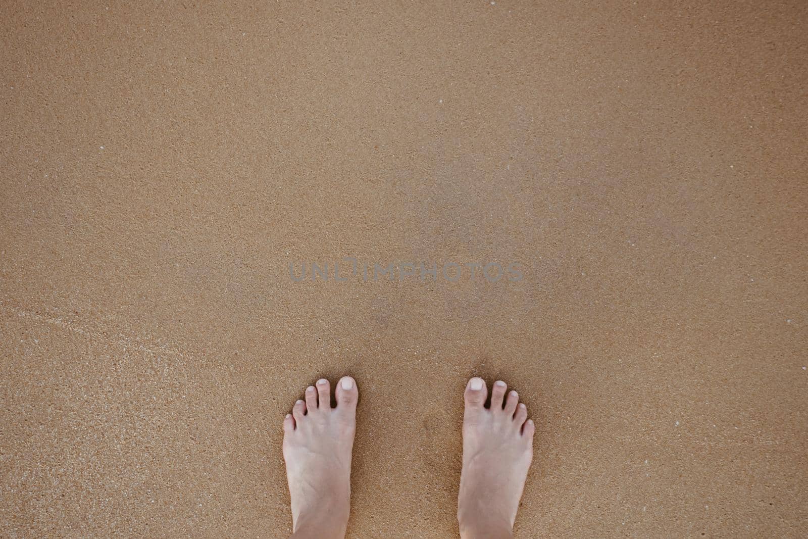 Summer vacation concept barefoot on sand at beach with copyspace background