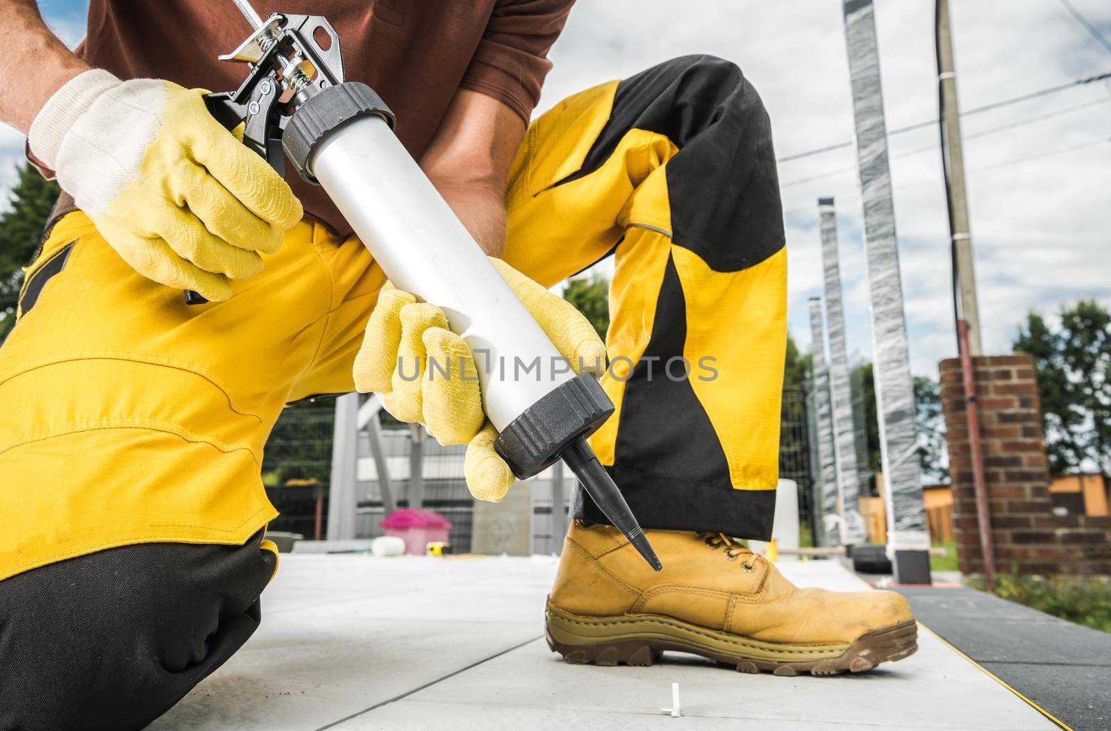 Professional Worker Using Outdoor Concrete Silicone by welcomia