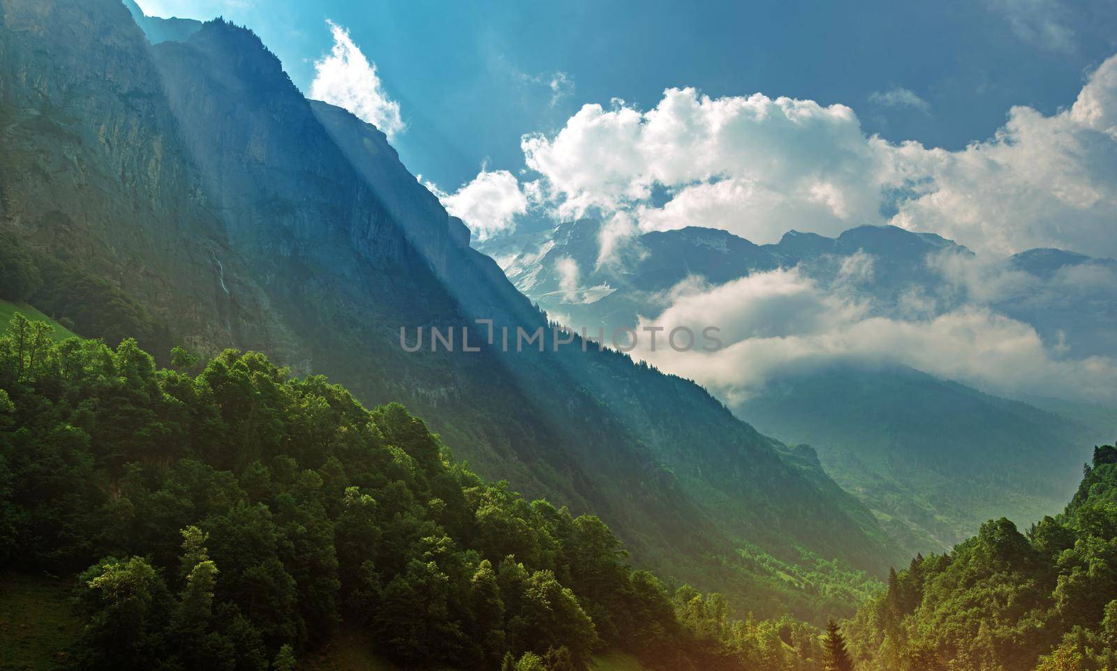 Scenic View Of Bright Sunny Canyon And Mountain Jungfrau Partly Coverd With Clouds In Beautiful Swiss Alps