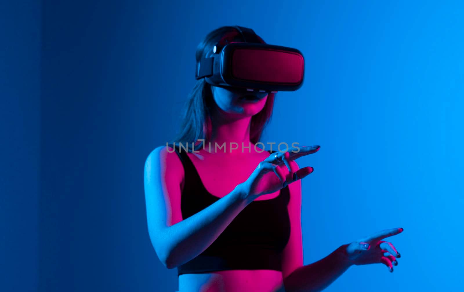 Portrait of woman video game designer wearing VR headset and interact with virtual environment or application