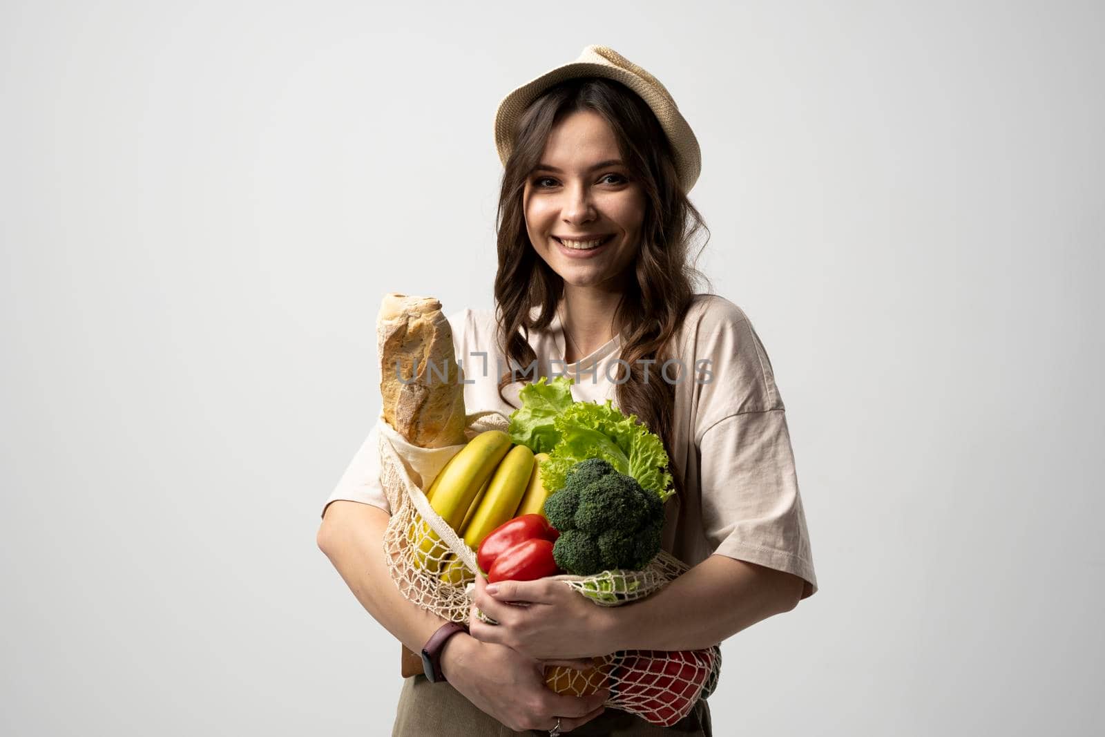 Portrait of young woman with a eco bag of vegetables, greens. Sustainable lifestyle. Eco friendly concept