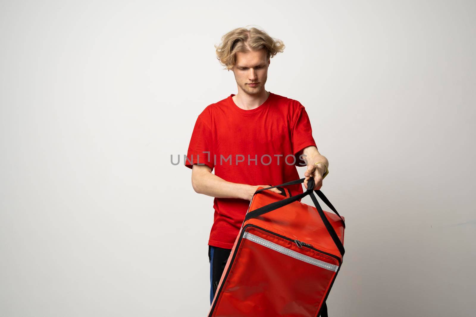 Courier with thermo bag and clipboard on white background, space for text. Food delivery service. by vovsht