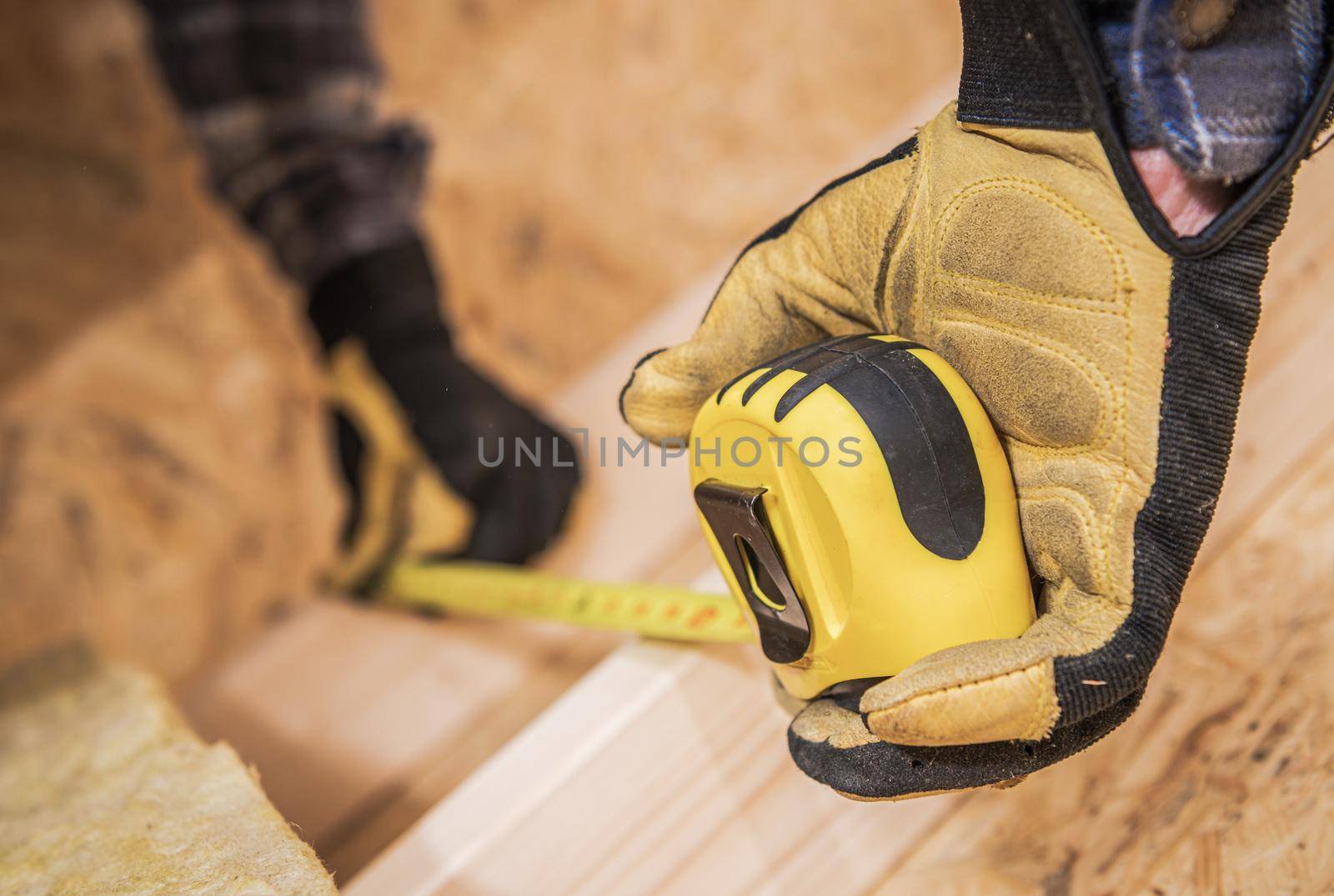 Worker with Measuring Tape Closeup. Dimensions Check. Construction Industry. by welcomia