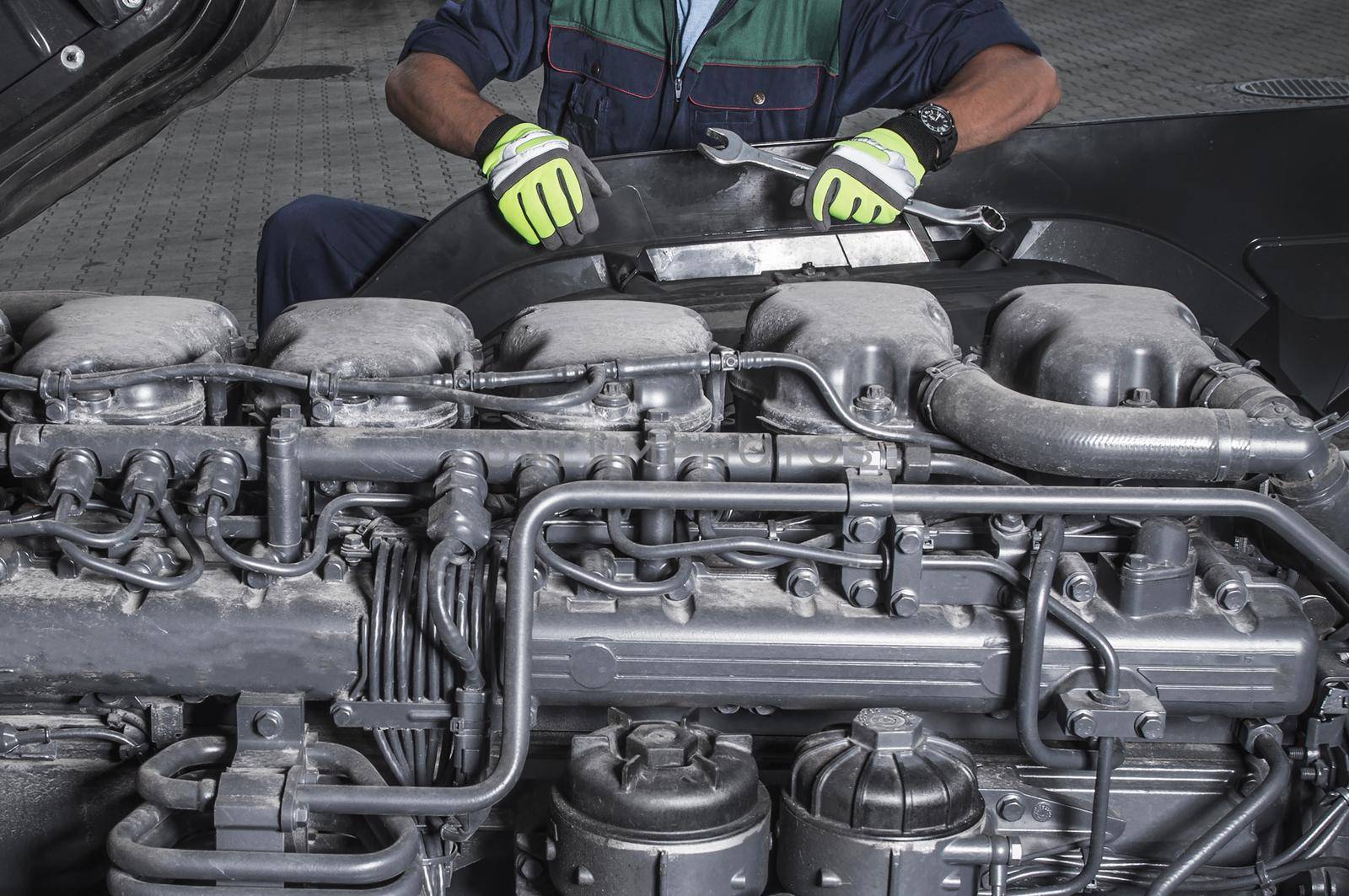 Heavy Duty Truck Diesel Engines Technician Maintain Scheduled Service Staying in Front of Modern Semi Truck Engine.