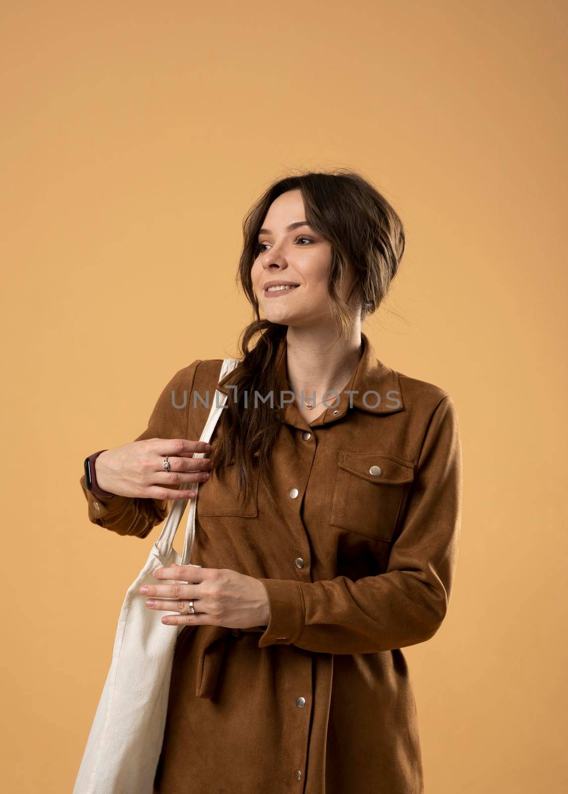 Ecology Concept. Woman holding cotton grocery bag with vegetables. Reusable eco bag for shopping. Zero waste concept. Eco friendly lifestyle. Isolated white background