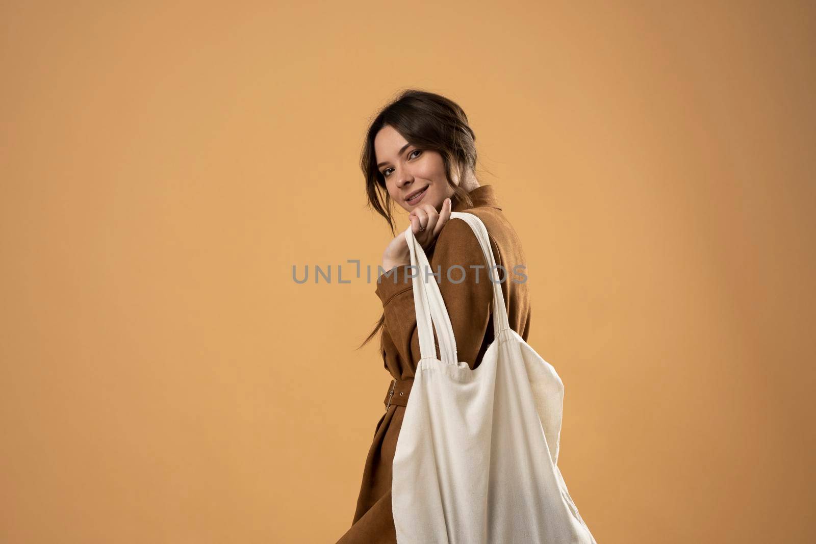 Ecology Concept. Woman holding cotton grocery bag with vegetables. Reusable eco bag for shopping. Zero waste concept. Eco friendly lifestyle. Isolated white background