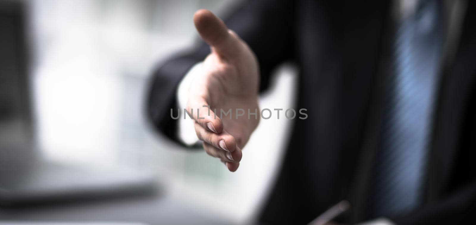 Portrait of a successful businessman giving a hand