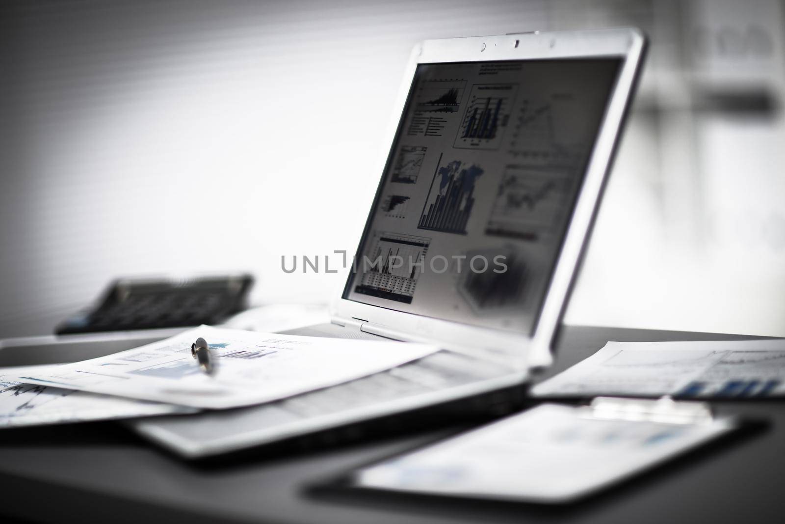 Businessman analyzing investment charts with laptop. Accounting
