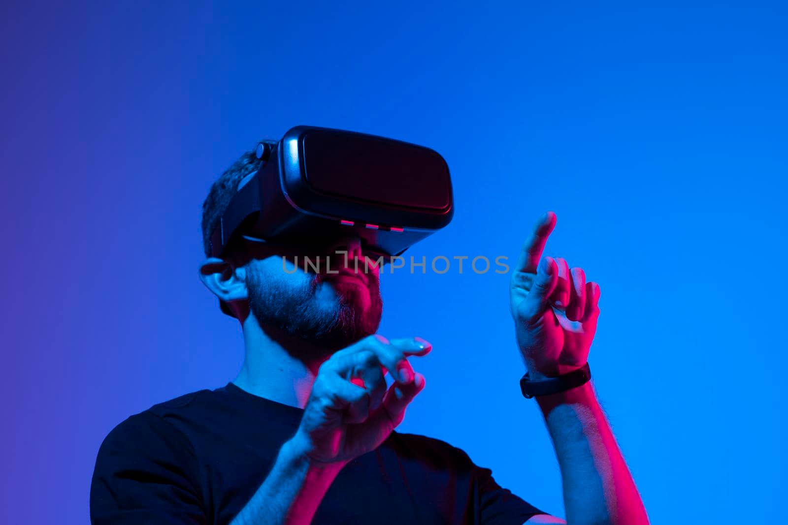 Happy and excited man playing racing video game with virtual reality headset in a metaverse world with a friends. Future technology concept. by vovsht