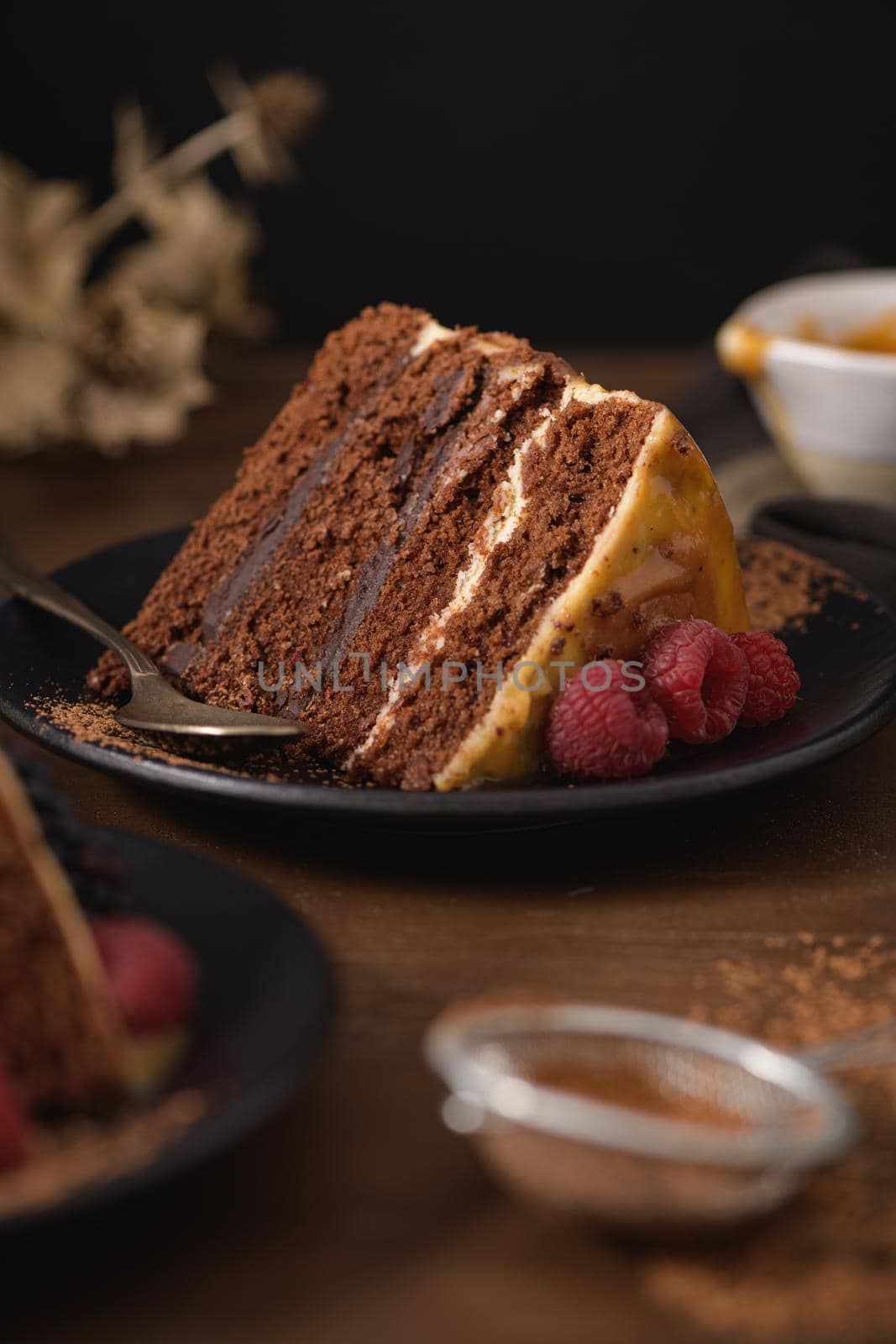 Delicious caramel cake slice with blackberries and raspberries.