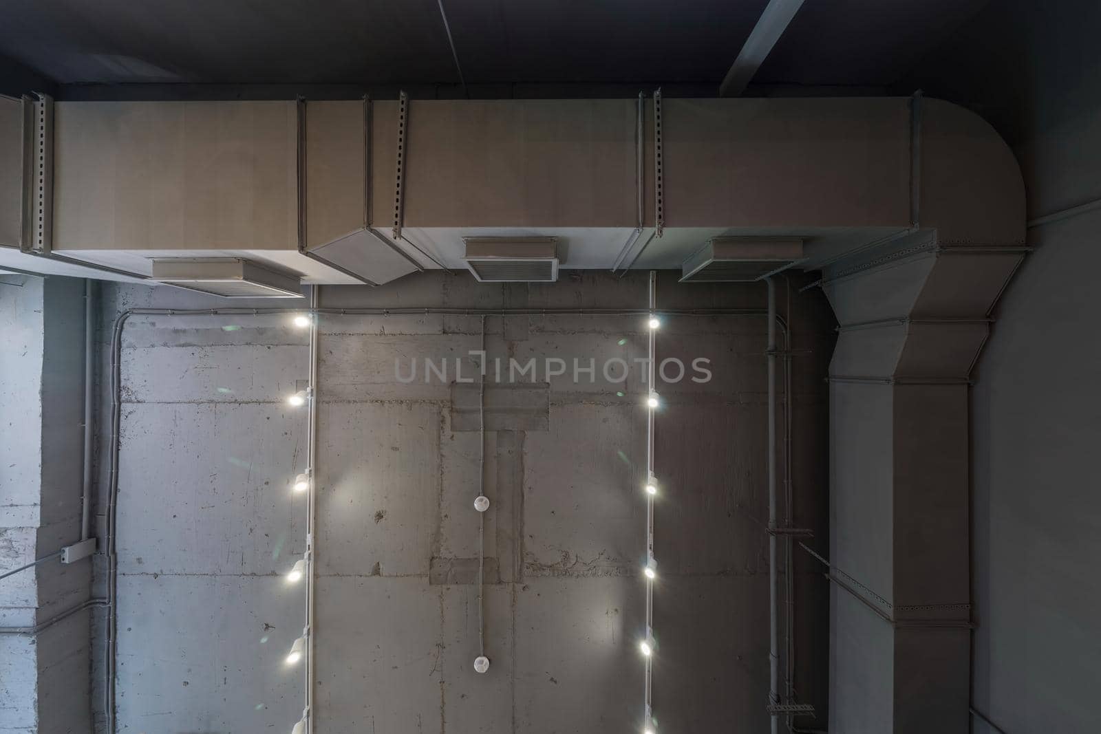 Abstract loft interior of concrete grey ceiling with air ventilation and security camera. Interior architecture and ceiling design of industrial loft building decorated with modern lamps by panophotograph