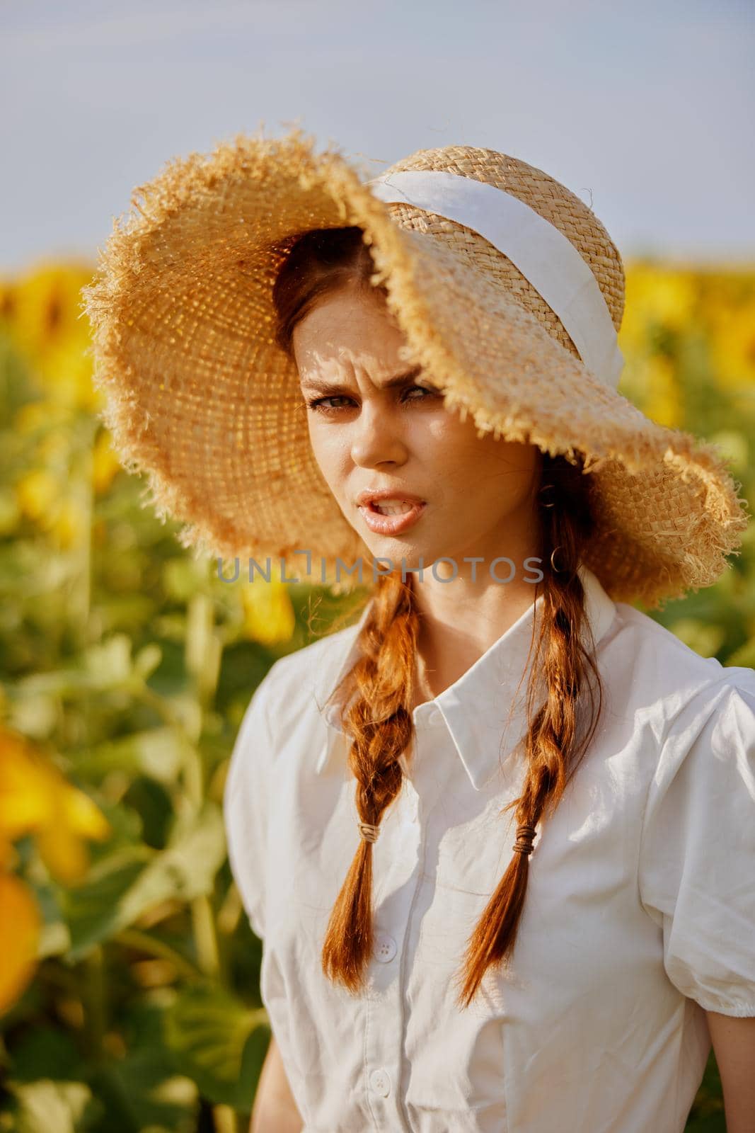 beautiful sweet girl in a field of sunflowers lifestyle unaltered. High quality photo