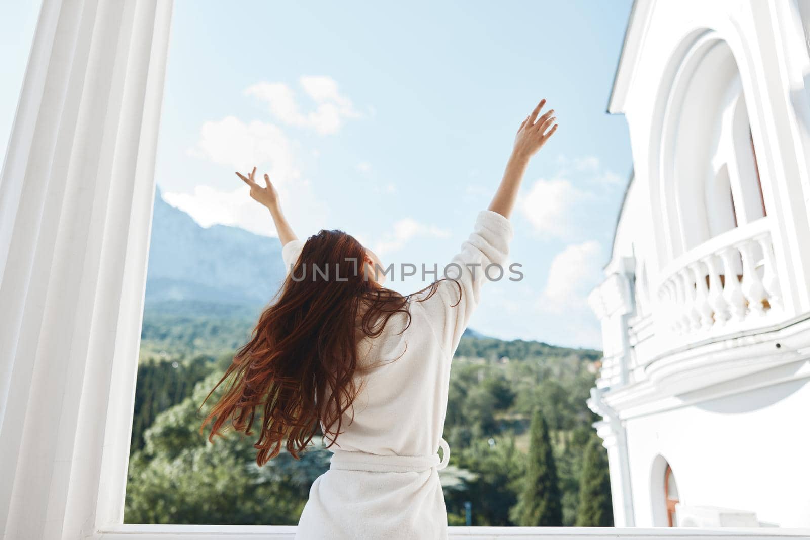 Attractive young woman hands up on the balcony Perfect sunny morning. High quality photo