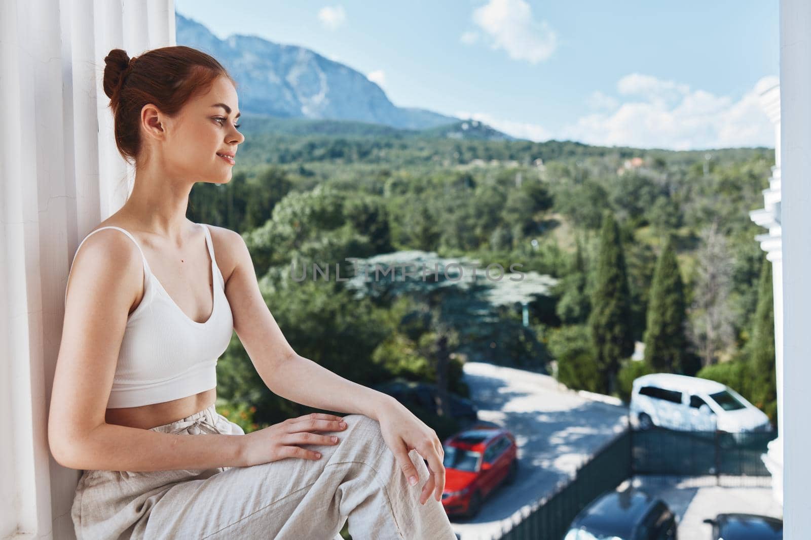beautiful woman sitting on the balcony city view Lifestyle. High quality photo