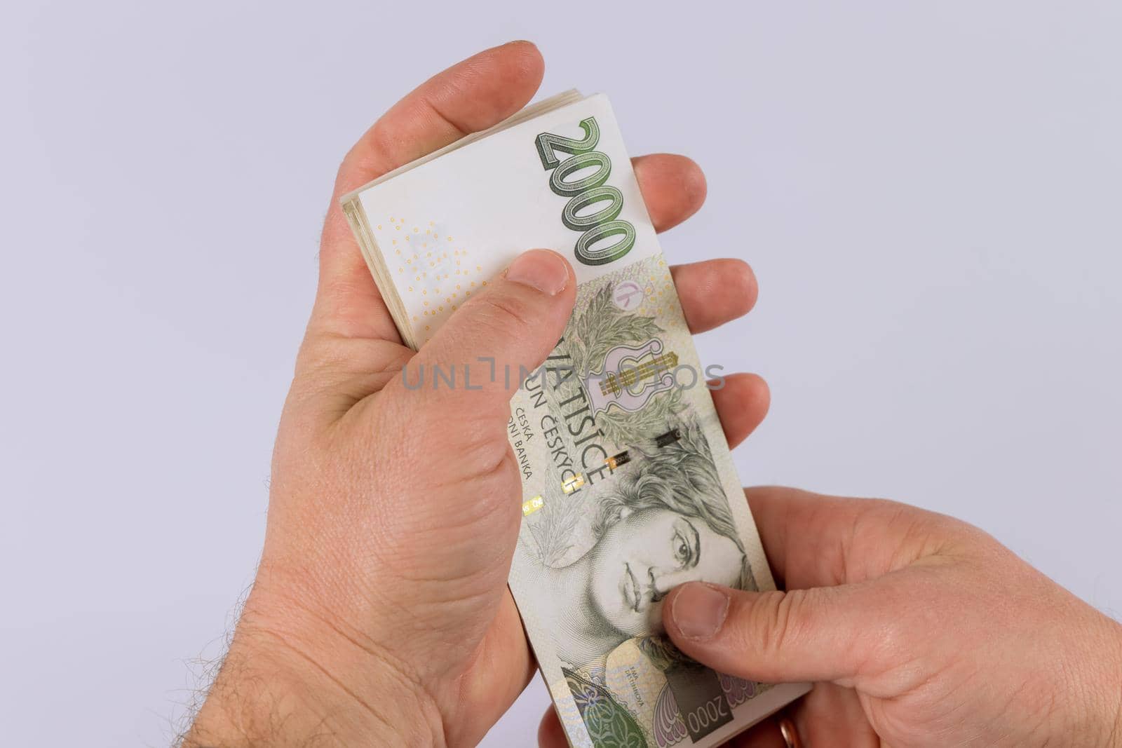 Detail of man hands counting czech koruna money