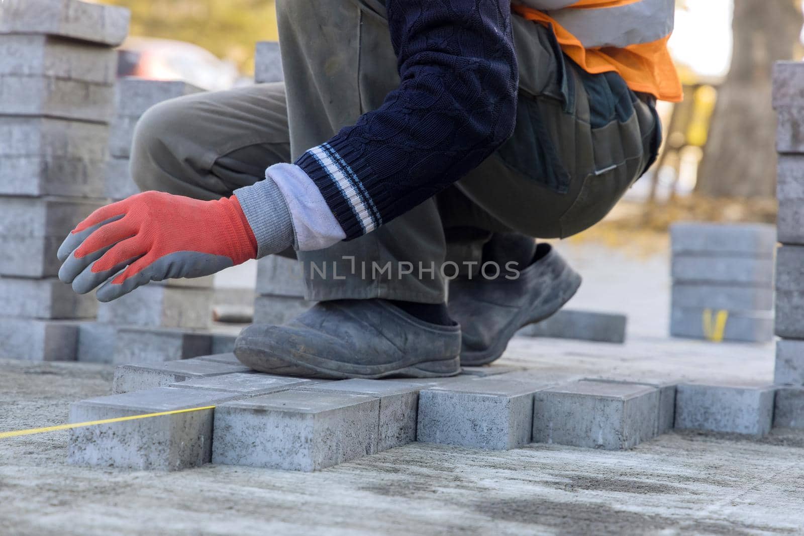 Installation of concrete bricks during sidewalk construction by ungvar