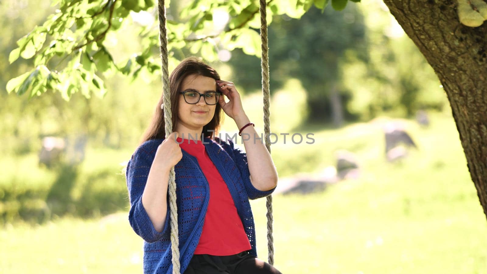Young beautiful long-haired girl on a rope swing. by DovidPro