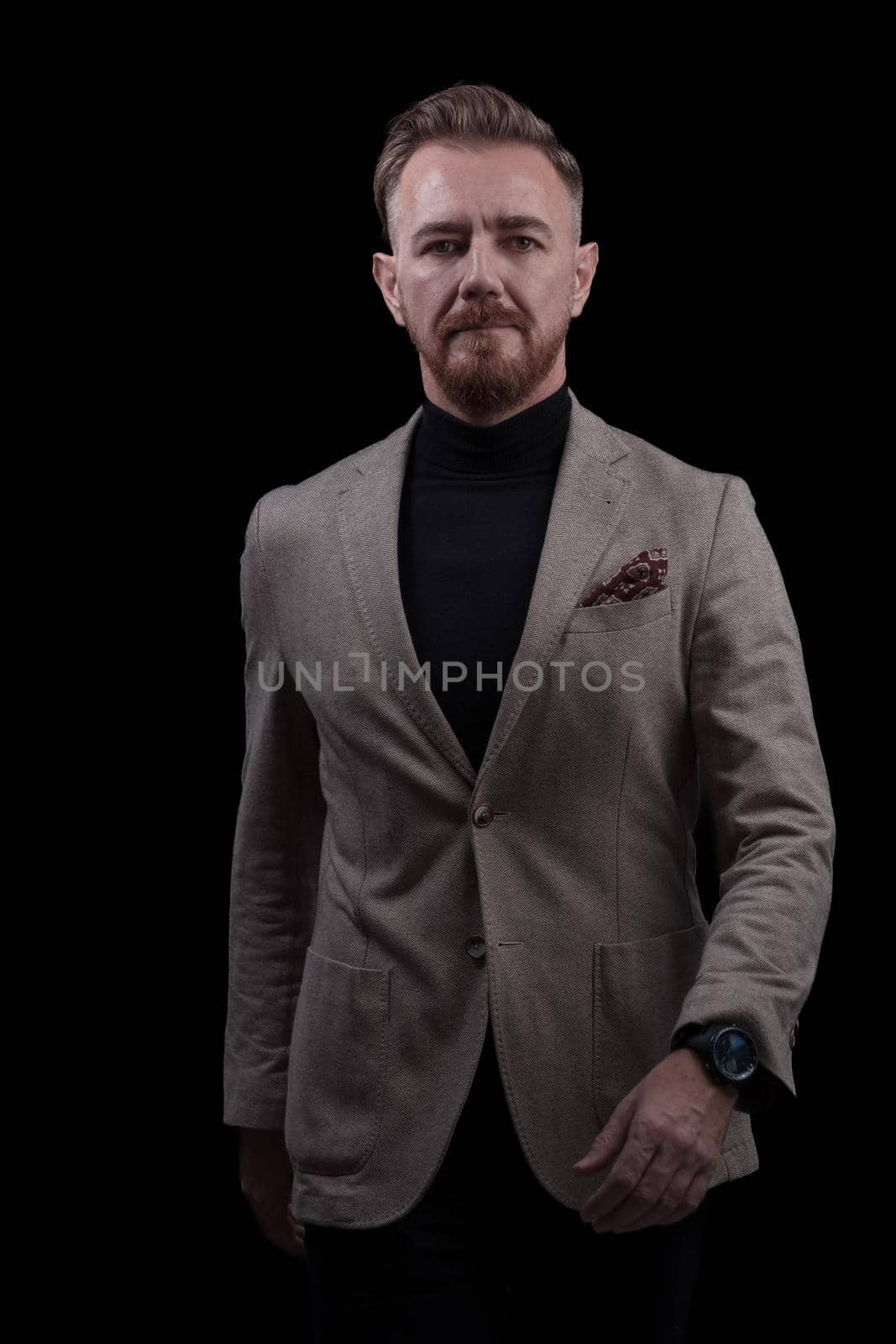 Confident businessman walking forward wearing a causal suit, handsome senior business man hero shot portrait isolated on black by dotshock