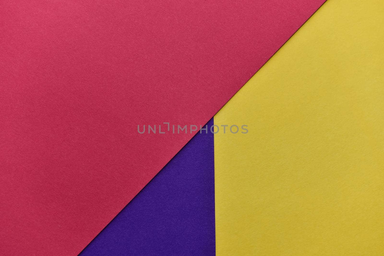 abstract geometric paper background. violet, yellow and red trendy colors. The backdrop for an invitation card, greeting card or web design. Creative copy space, flat lay.